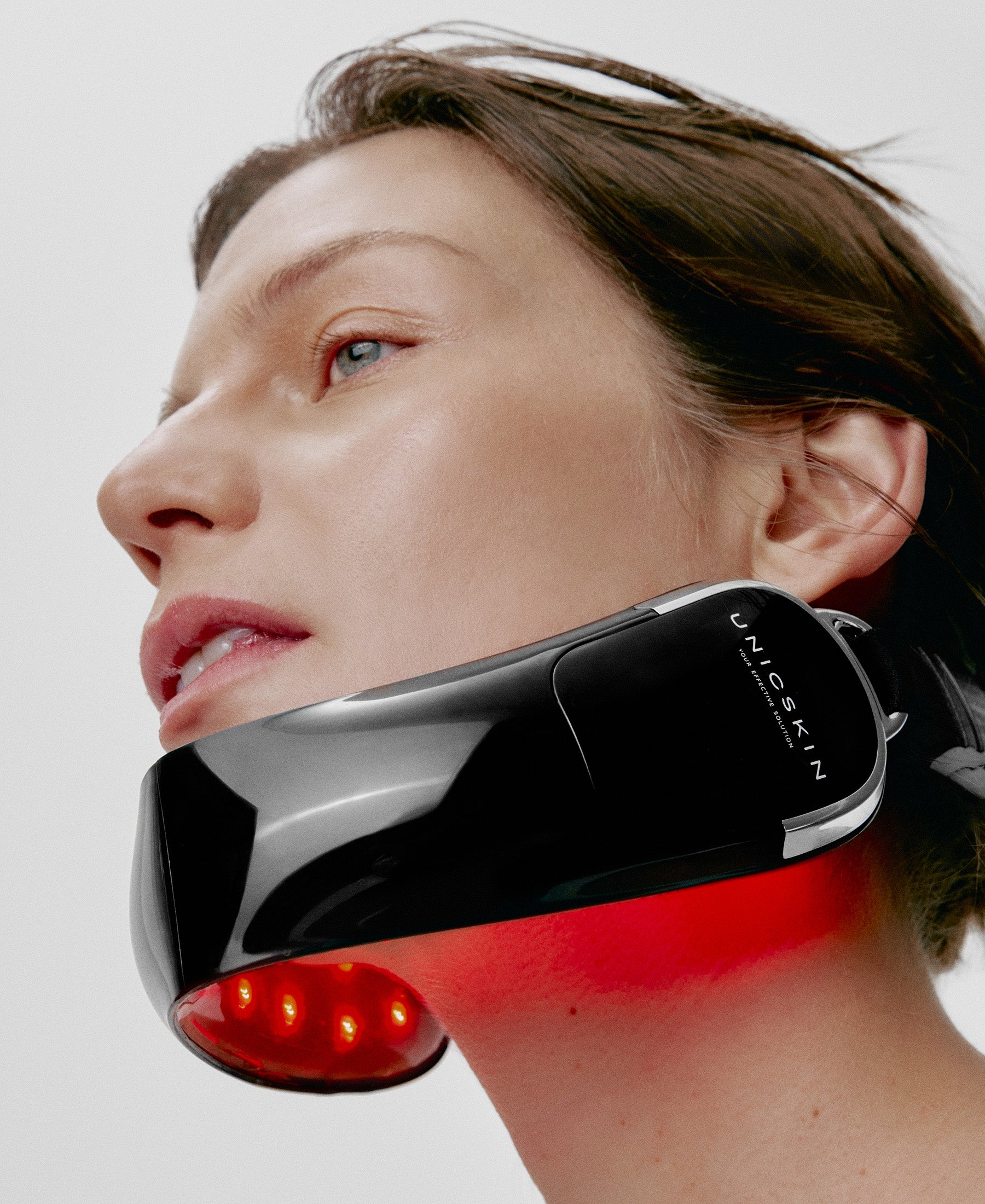 UNICskin UNICLED Neck & Chin device for tightening, lifting, and reducing wrinkles in the neck and chin area. Combines LED light therapy for a more youthful, defined contour.