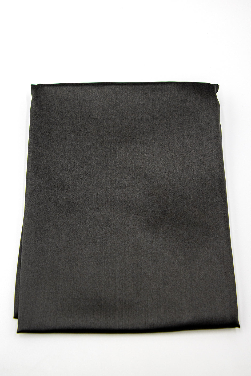 The Sagrada Mulberry Silk Pillowcase by Sagrada BioSkincare, crafted from luxurious dark gray 22-momme silk, pampers your skin and hair while you rest and is known for its thermoregulating properties.