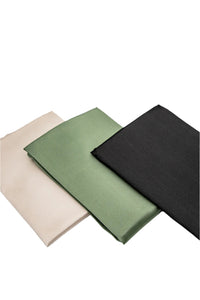 Three Sagrada BioSkincare Sagrada Mulberry Silk Pillowcases, in beige, green, and black 22-momme silk with thermoregulating properties, are neatly folded and arranged side by side on a white background.