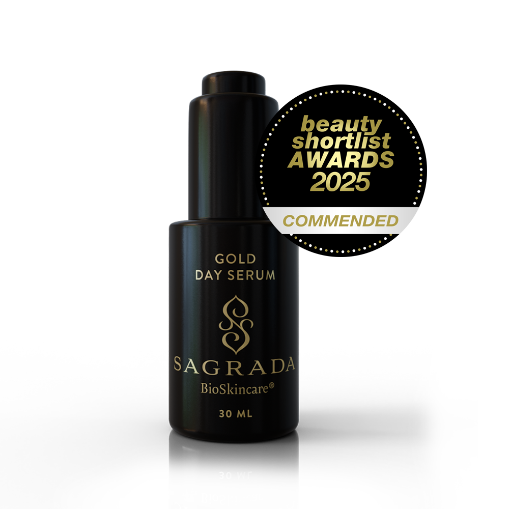 A 30ml bottle of Sagrada BioSkincare Sagrada Day Gold Serum - Radiance Boosting Elixir is displayed next to a gold “beauty shortlist AWARDS 2025 COMMENDED” badge.