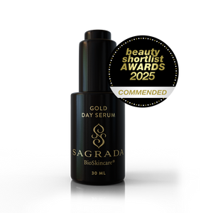 A 30ml bottle of Sagrada BioSkincare Sagrada Day Gold Serum - Radiance Boosting Elixir is displayed next to a gold “beauty shortlist AWARDS 2025 COMMENDED” badge.