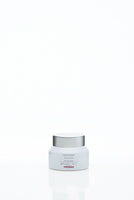 A white Pietro Simone Skin Alert Unguent jar with a silver lid sits centered on a minimalist background, suggesting luxurious care for calming redness and irritation, while its subtle front text highlights refined simplicity.