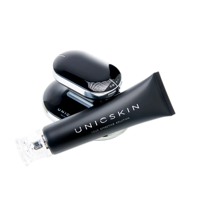 A sleek black tube labeled "Adverto Beauty UNICBODY Slim Action x4 - High Tech Multi-Action Body Contour & Shaping Cream" rests in front of a shiny, oval-shaped beauty device, both displayed on a white background.