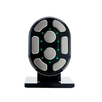 The UNICskin UNICBODY Slim by Unic Skin is a black, oval device with silver pads and green lights, designed for non-invasive firming, tightening, and smoothing to achieve a leaner, toned look. Displayed vertically on a rectangular black base.