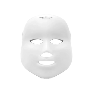 The UNICskin Korean LED Mask by Unic Skin features a white, expressionless design with eye, nose, and mouth openings. “UNICSKIN” is printed on the forehead, making it a standout skincare device for acne, hyperpigmentation, and aging.